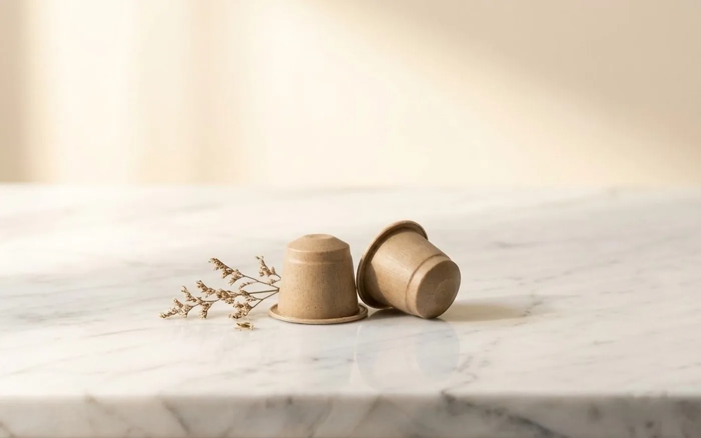 Compostable coffee pods made from plant-based bioplastic on white marble