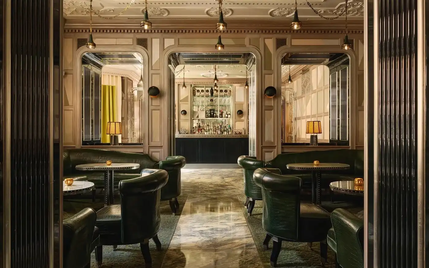 Green crocodile-leather armchairs and mirrored arches at The Connaught Bar in Mayfair, London