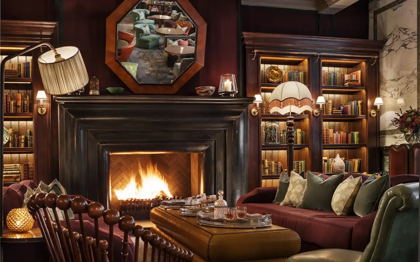 Fireplace and library shelves in Scarfes Bar at Rosewood London, Holborn