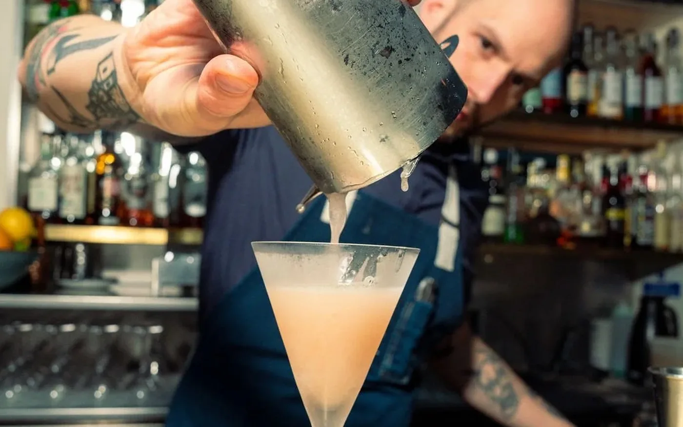 Bartender pouring a cocktail at Swift cocktail bar in Soho, London