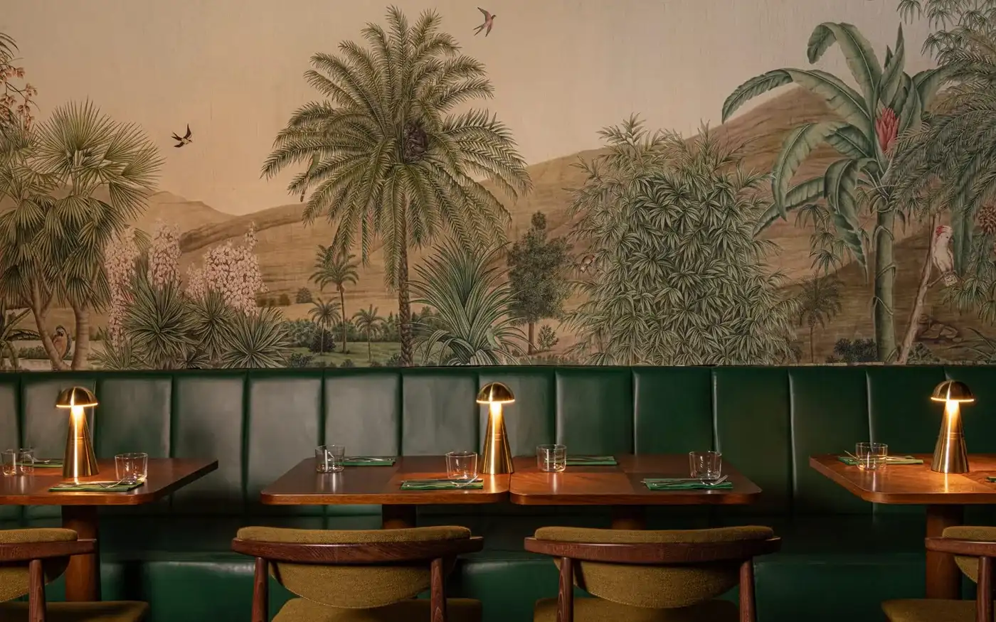 Jungle mural and green leather banquette at Oriole cocktail bar in Covent Garden, London
