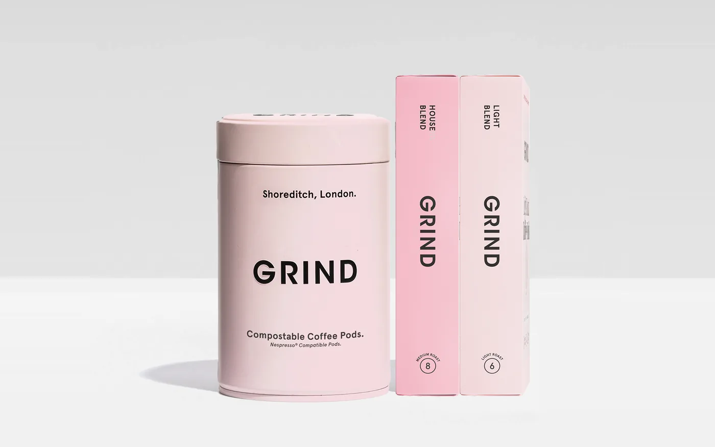 Grind compostable coffee pods tin with House Blend and Light Blend pod boxes
