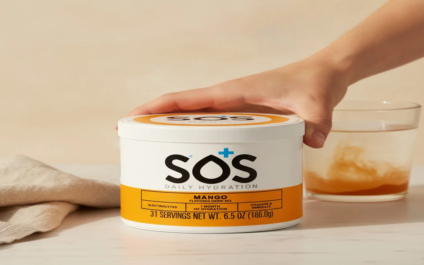 SOS Hydration sticks laid out on a white surface beside a water bottle