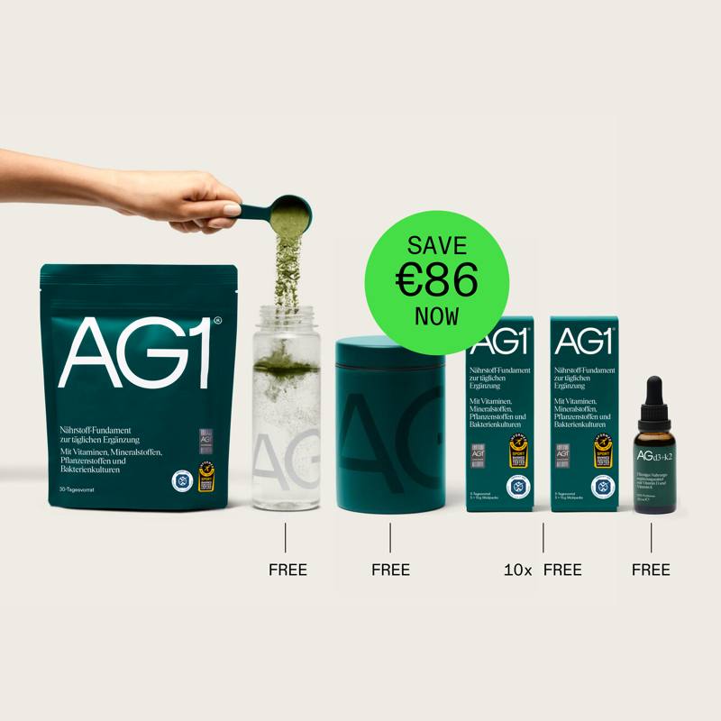 AG1 greens powder sachet and shaker bottle on a kitchen counter