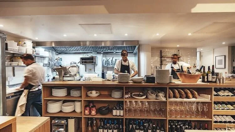 Legare restaurant open kitchen and wine shelves, Italian dining in Bermondsey, London