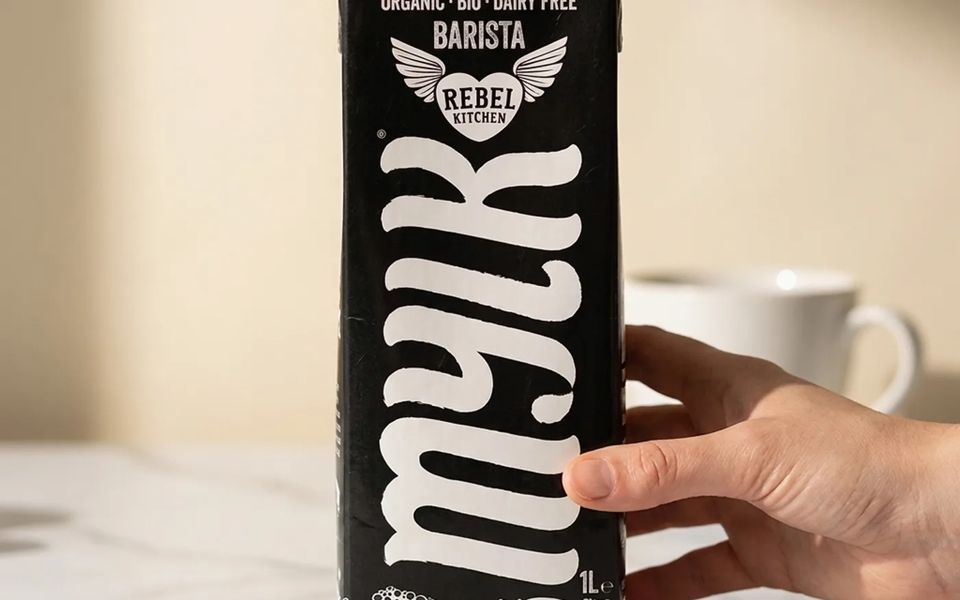 Rebel Kitchen Organic oat milk carton with green and white packaging