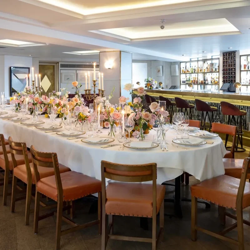 The Original Ivy private dining room with a long candlelit table, West End, London