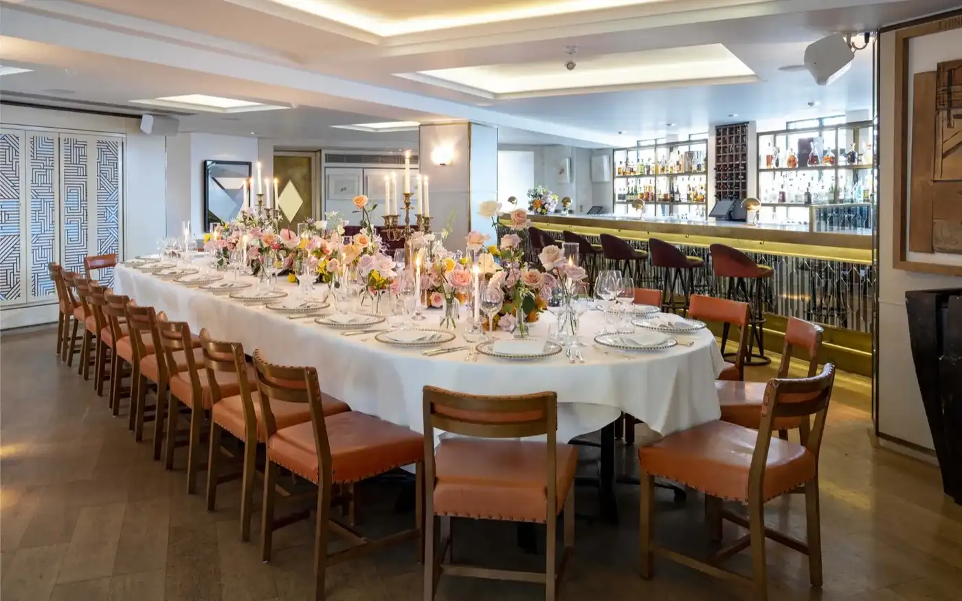 The Original Ivy private dining room with a long candlelit table, West End, London