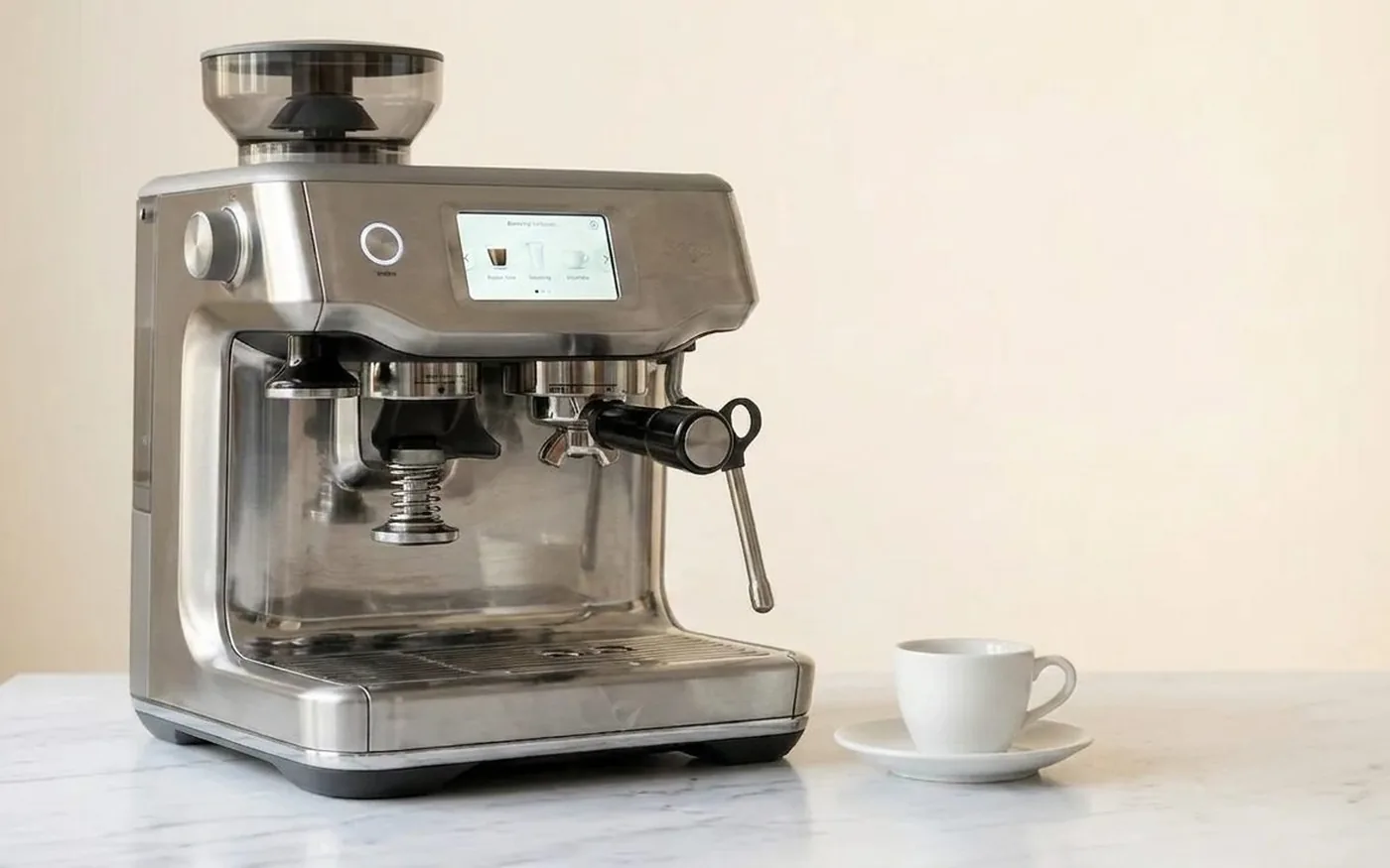 Sage Barista Touch Impress with touchscreen display and auto-tamping on white marble kitchen counter