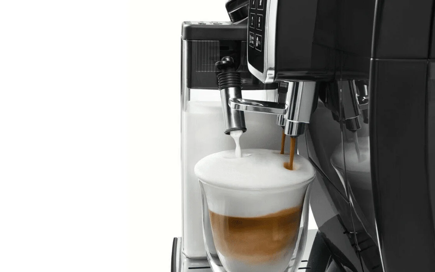 De'Longhi Dinamica dispensing a creamy latte into a double-walled glass cup