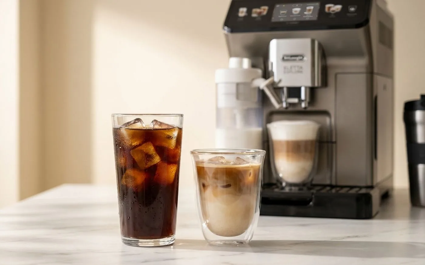 Two glasses of cold brew and iced coffee drinks prepared by the De'Longhi Eletta Explore