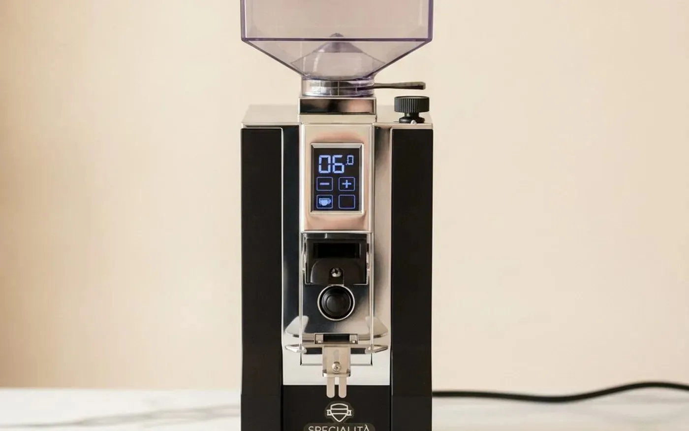 Eureka Mignon Specialita coffee grinder on white marble countertop