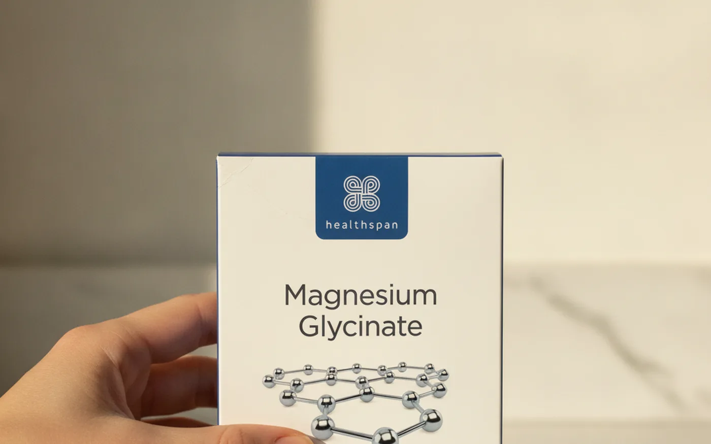 Healthspan Magnesium Glycinate supplement box on white marble surface