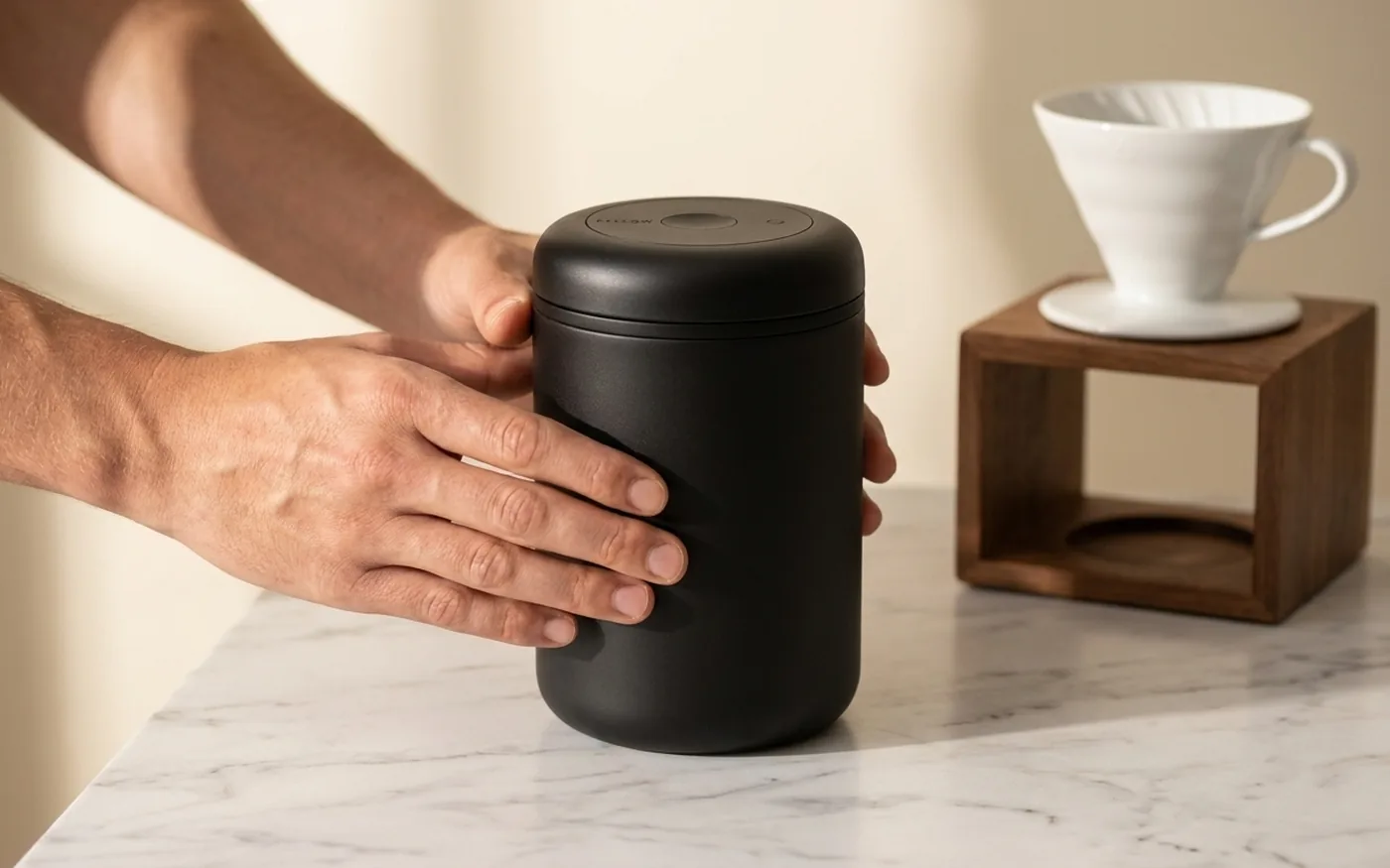 Fellow Atmos vacuum canister used for storing coffee beans