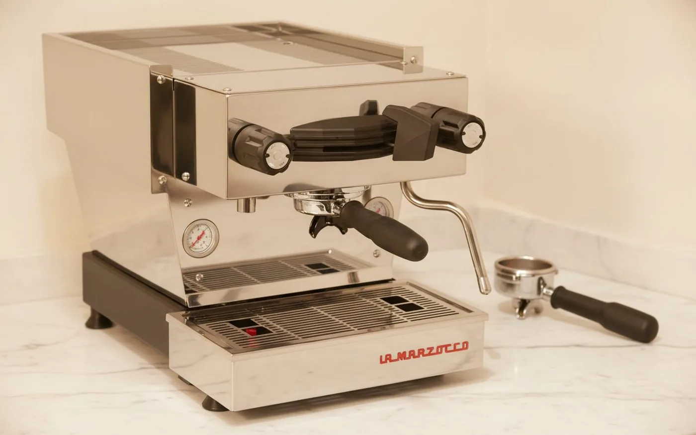 La Marzocco Linea Mini stainless steel espresso machine on white marble showing build quality and footprint