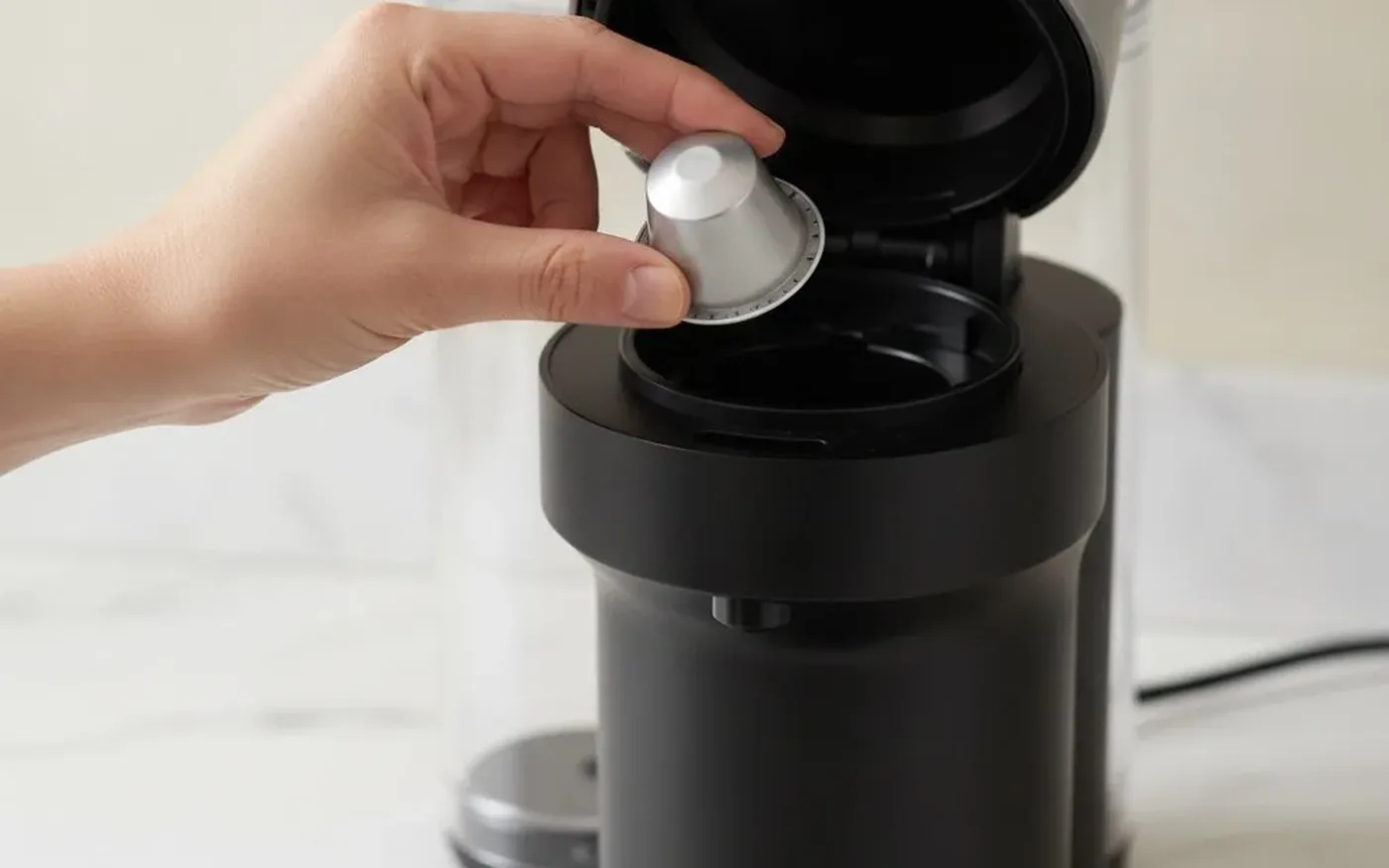 Loading a Nespresso Vertuo capsule into the machine