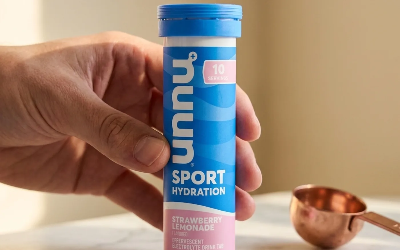 Nuun Sport electrolyte tablets and tube on a marble surface