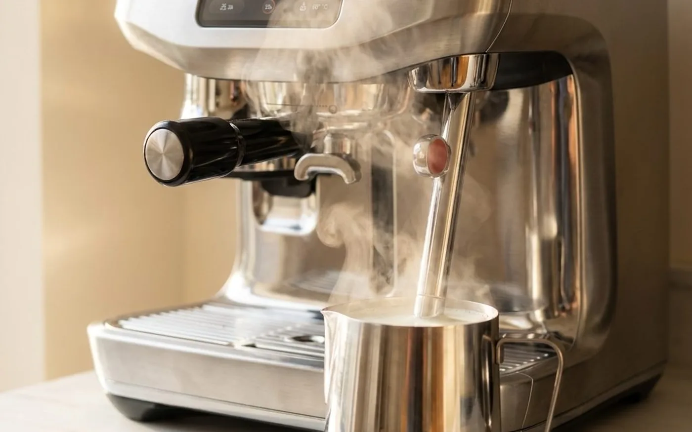 Sage Oracle Jet steam wand texturing milk in silver jug for flat white