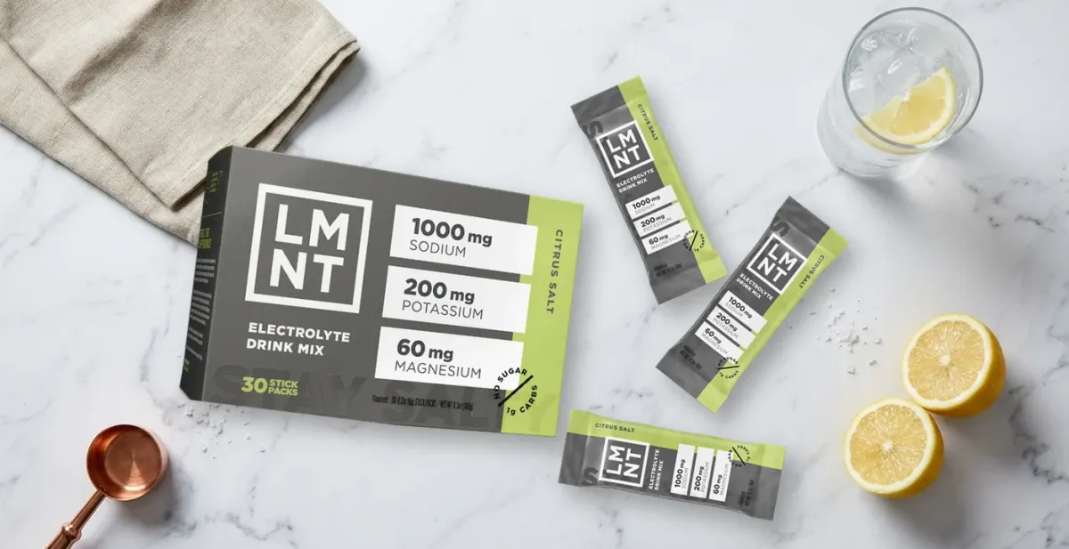 LMNT electrolyte drink sachets and sticks on a marble surface — LMNT Review UK 2026